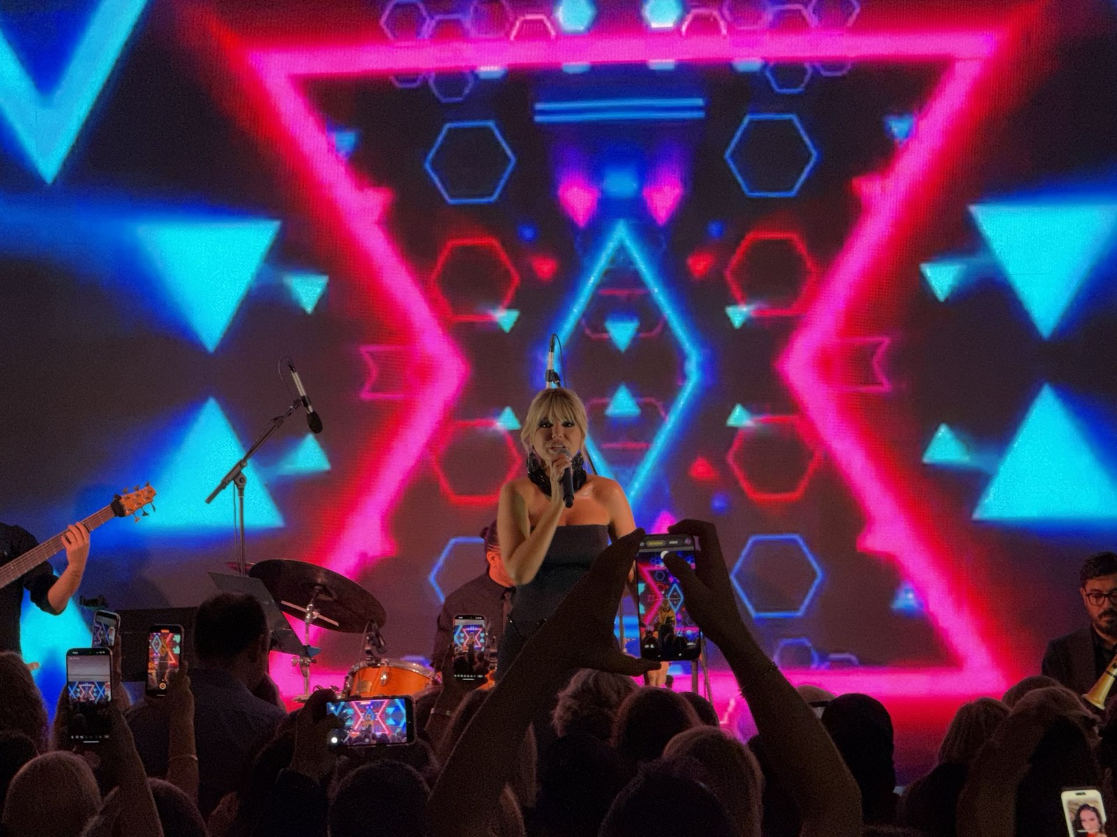 Singer in front of neon LED wall